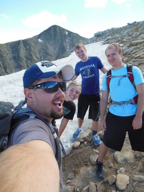 Ryan in Colorado with his family atop a snowy mountain